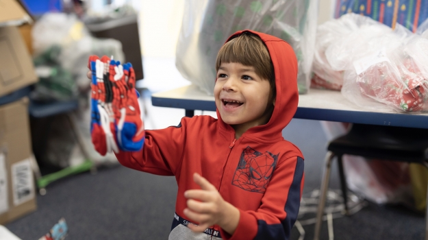 Happy child holding Spiderman socks