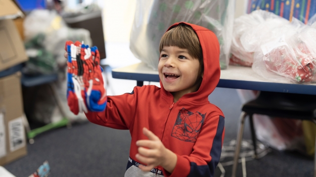 Happy child holding Spiderman socks